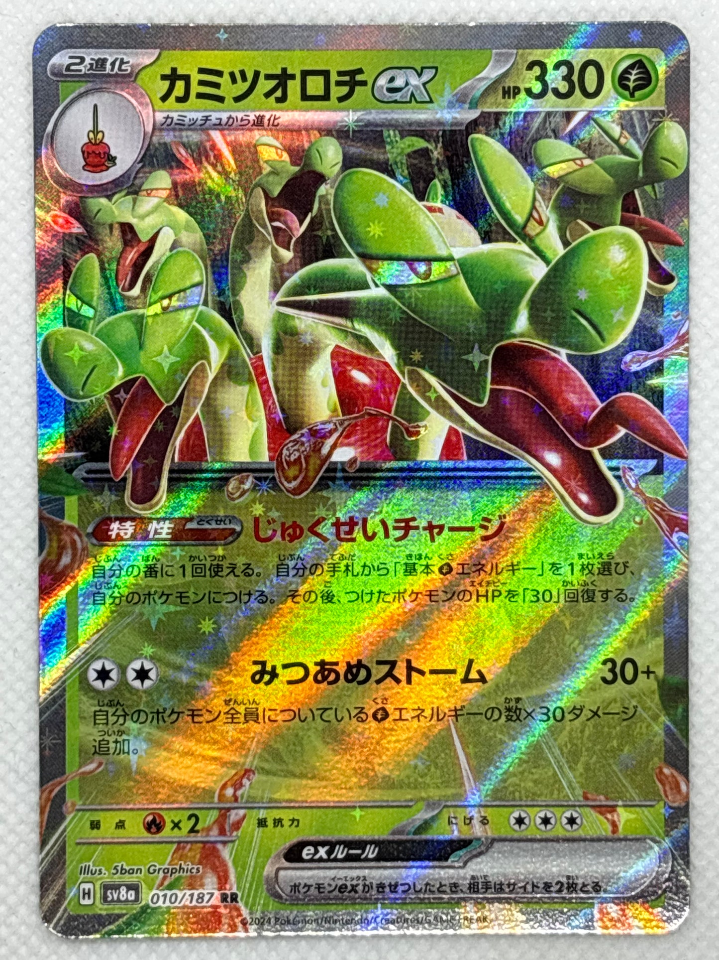 Hydrapple card showing its details, abilities, and its role in the Terastal Festival ex set of the Scarlet & Violet series.